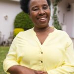 portrait-happy-senior-african-american-woman-wearing-yellow-shirt-garden-home_13339-369984